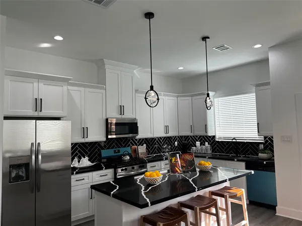 a kitchen with a refrigerator a sink and a stove