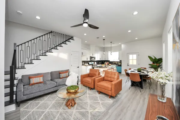 a living room with furniture and a chandelier