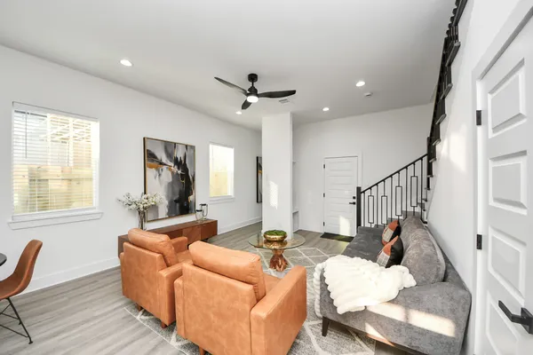 a living room with furniture and a chandelier