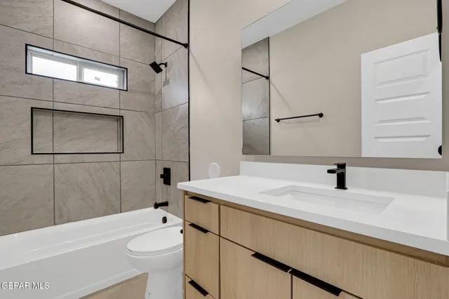 a bathroom with a sink and a large mirror