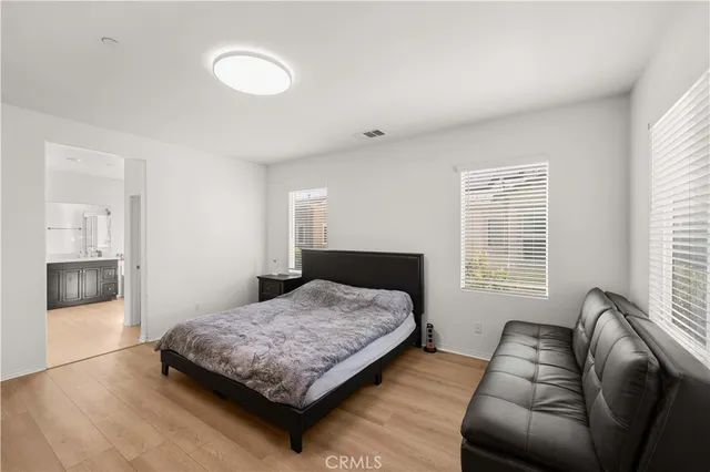 a bedroom with a bed couch and window