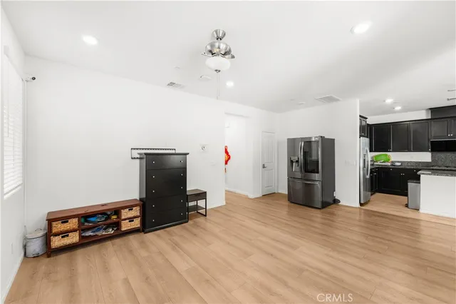 a kitchen with stainless steel appliances a refrigerator and a stove top oven