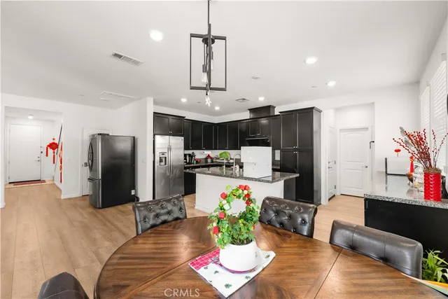 a living room with stainless steel appliances kitchen island granite countertop furniture and a view of kitchen