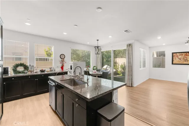 a large kitchen with kitchen island a sink stainless steel appliances and cabinets