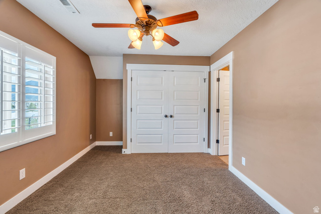 1355 West 1000 South Mapleton, UT 84664 - Photo 45 of 74 Unfurnished bedroom featuring a closet, carpet floors, ceiling fan, and vaulted ceiling