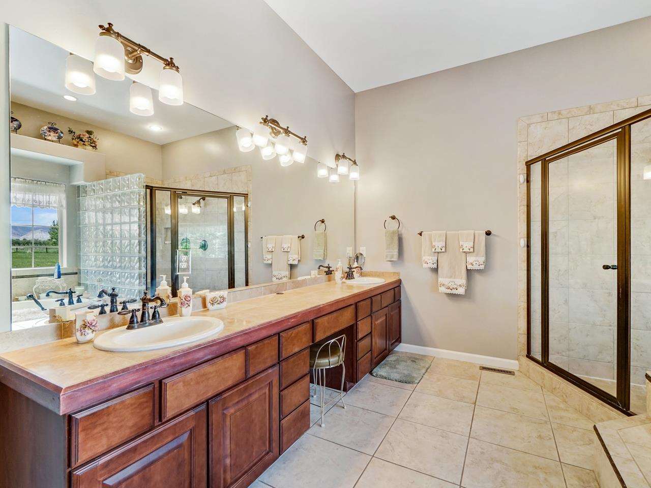 1110 22 Road Grand Junction, CO 81505 - Photo 27 of 42 a spacious bathroom with a double vanity sink mirror and shower