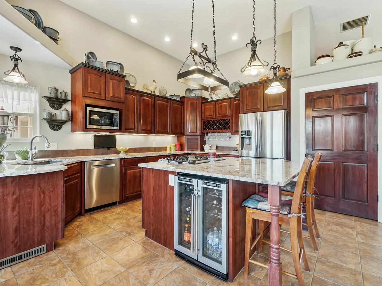 1110 22 Road Grand Junction, CO 81505 - Photo 10 of 42 a kitchen with stainless steel appliances granite countertop a stove a sink dishwasher and a refrigerator with wooden floor