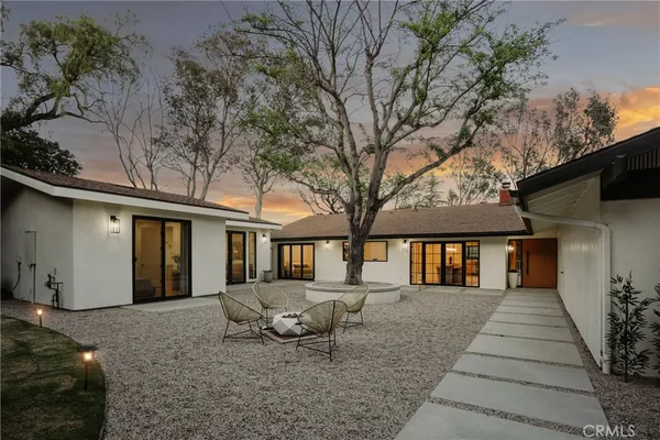 a front view of house with yard and seating space