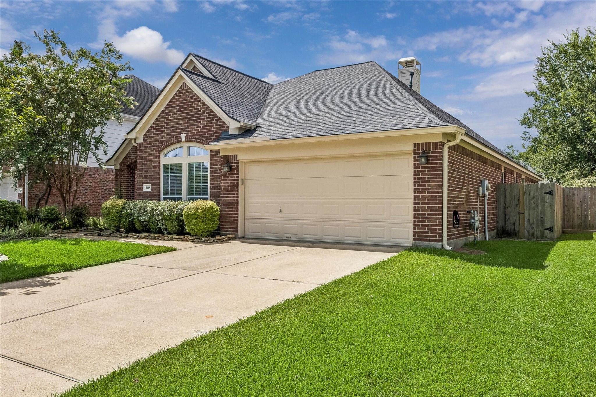 3118 Valley Court Manvel, TX 77578 - Photo 36 of 38 This charming brick home features a well-maintained front lawn, a two-car garage, and a cozy entryway. It's complemented by mature trees and shrubs, providing excellent curb appeal in a quiet, suburban setting.