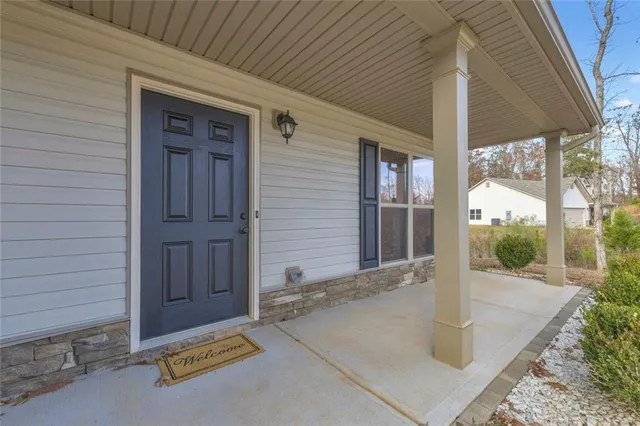 wooden floor in an empty room with a chandelier