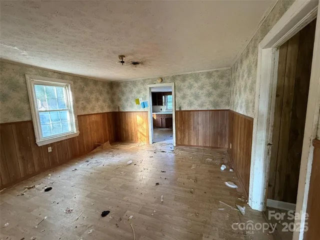 an empty room with windows and closet