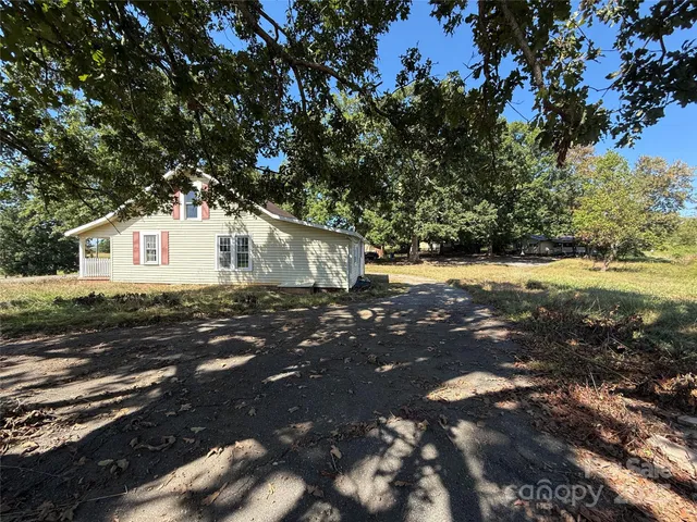 a view of a yard with large trees