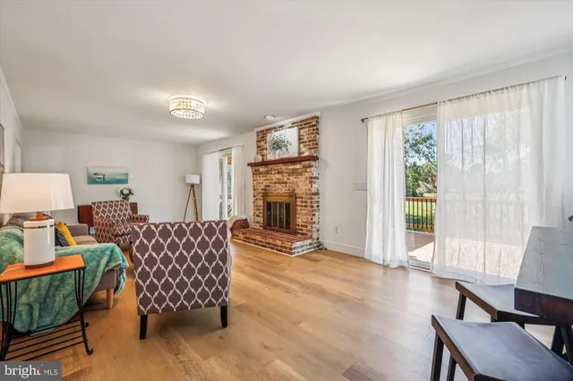 a living room with furniture fireplace and window