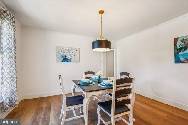 a dining room with furniture and wooden floor