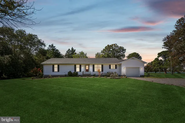 a house that has a big yard with wooden fence