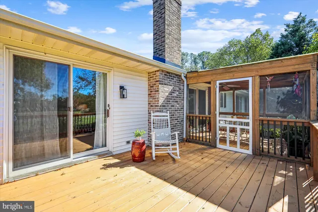 a front view of a house with patio outdoor seating and wooden floor