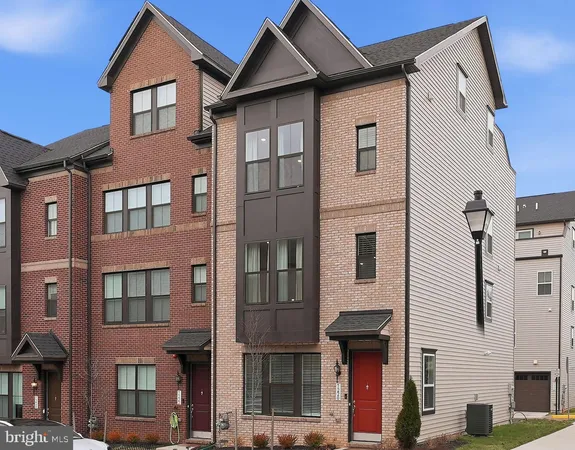 a front view of a residential apartment building with a yard