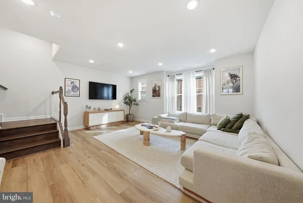 a living room with furniture and flat screen tv