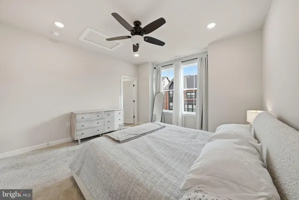 a bedroom with a large bed and a ceiling fan