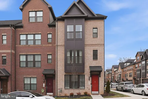 a front view of a residential apartment building with a yard
