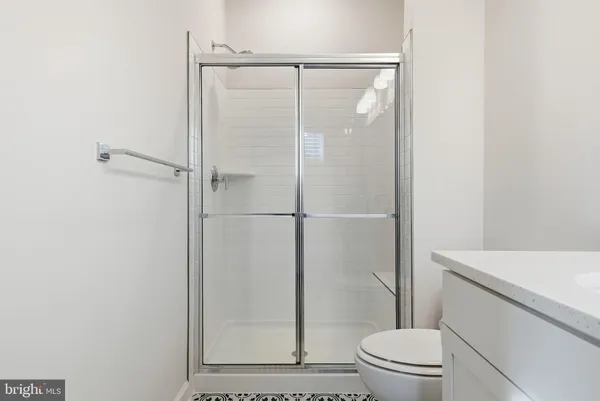 a bathroom with a shower a toilet and a sink