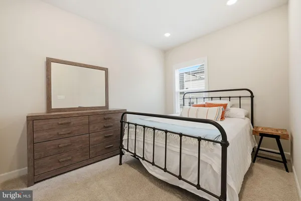 a bedroom with a bed and a dresser