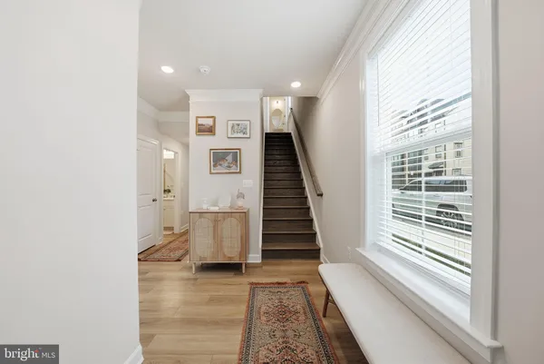 a view of entryway with wooden floor and stairs
