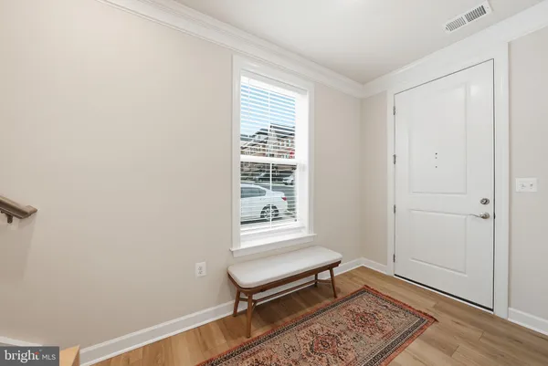 a bench sitting in a room next to a window