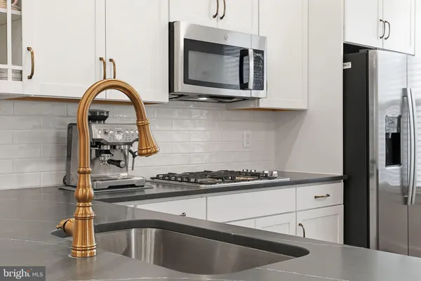 a kitchen with granite countertop a stove and a sink