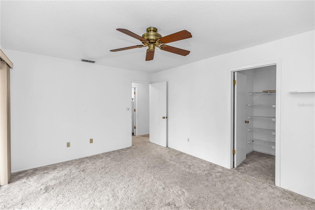 55 Crooked Pine Road Port Orange, FL 32128 - Photo 18 of 28 a view of a hallway with a ceiling fan