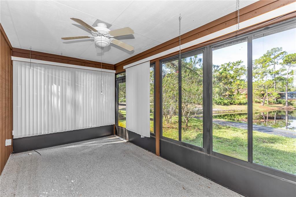 55 Crooked Pine Road Port Orange, FL 32128 - Photo 20 of 28 a view of a livingroom with a ceiling fan and a large window