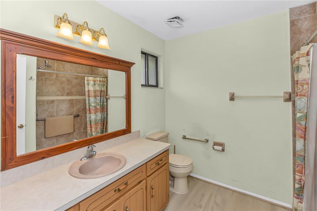 55 Crooked Pine Road Port Orange, FL 32128 - Photo 23 of 28 a bathroom with a granite countertop sink and a mirror
