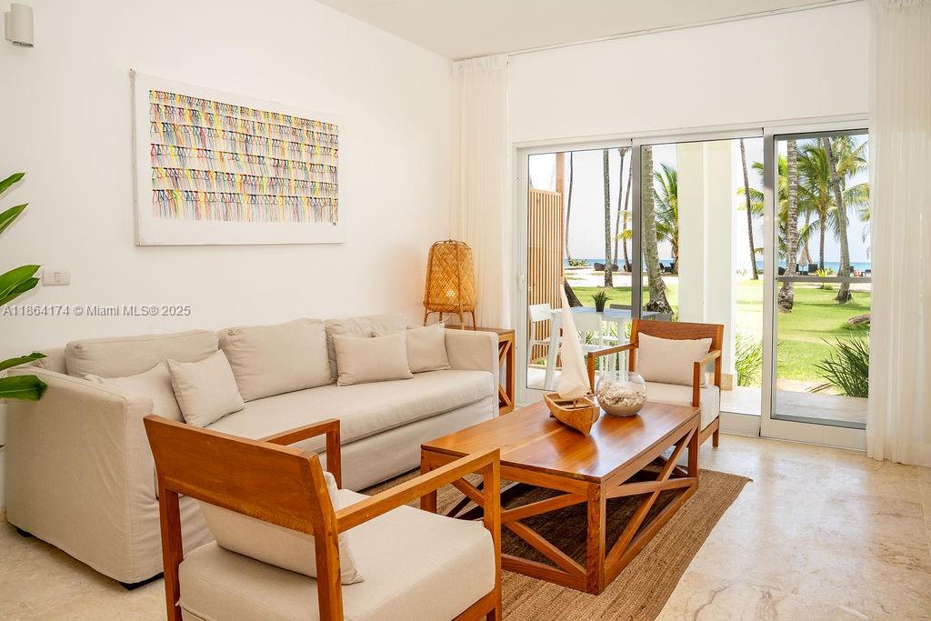 0 8c3f Q62, Unit LEVEL 1 Las Terrenas, Samaná Province 32000 - Photo 1 of 41 a living room with a couch and a large window