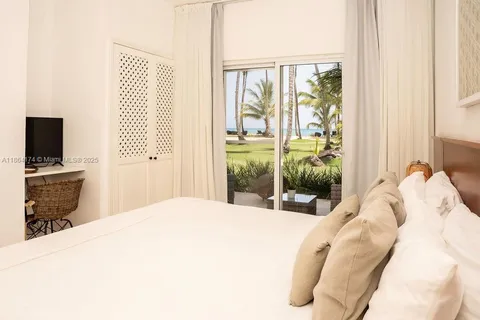 a bedroom with a bed and a television