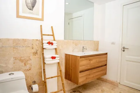 a bathroom with a sink mirror vanity and toilet