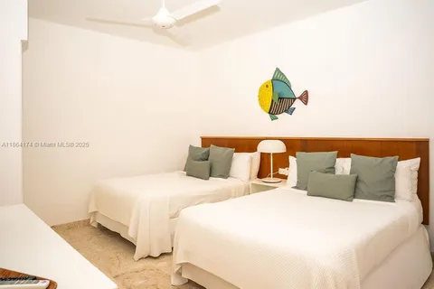 a bedroom with a bed and painting on the wall