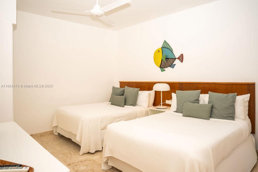 0 8c3f Q62, Unit LEVEL 1 Las Terrenas, Samaná Province 32000 - Photo 16 of 41 a bedroom with a bed and painting on the wall