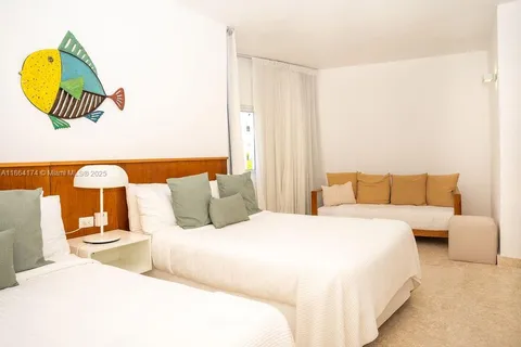 a bedroom with a bed and a couch