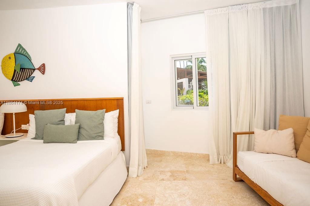 0 8c3f Q62, Unit LEVEL 1 Las Terrenas, Samaná Province 32000 - Photo 20 of 41 a bedroom with a bed and a couch