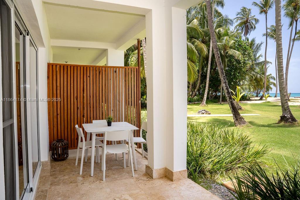 0 8c3f Q62, Unit LEVEL 1 Las Terrenas, Samaná Province 32000 - Photo 21 of 41 a view of a dining room with a table and chairs