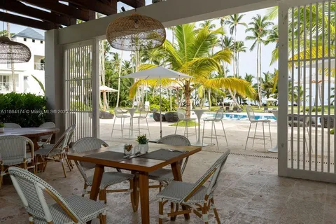 a view of a patio with table and chairs and potted plants