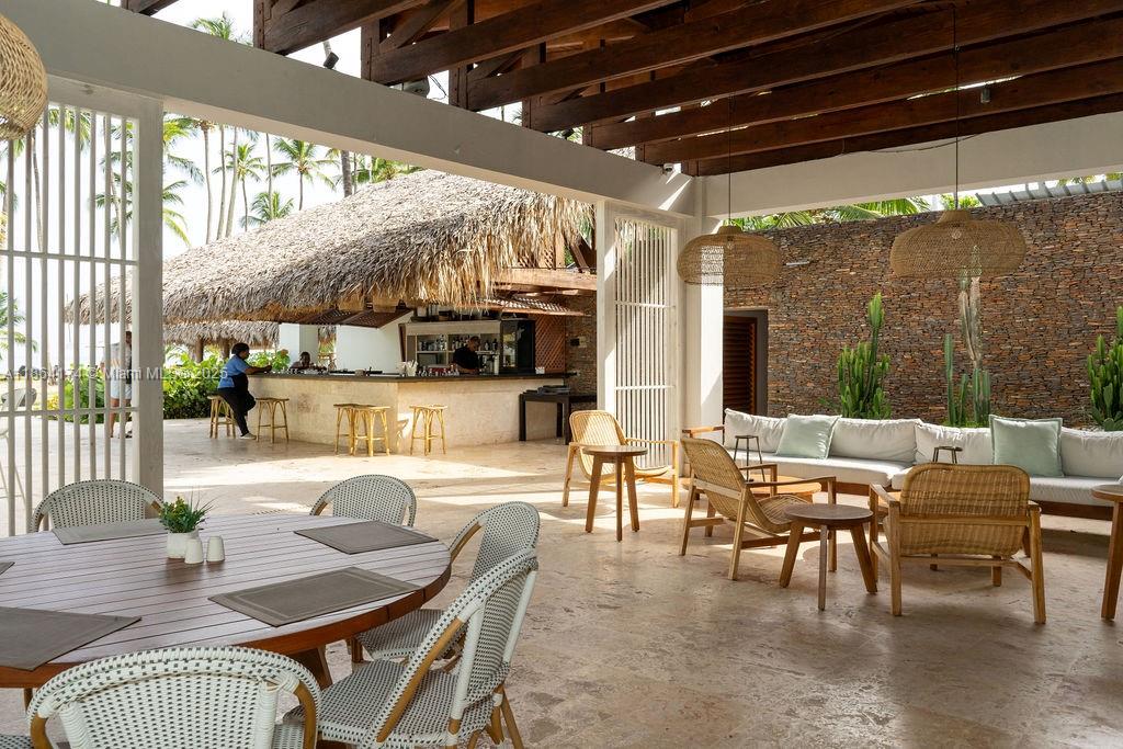 0 8c3f Q62, Unit LEVEL 1 Las Terrenas, Samaná Province 32000 - Photo 23 of 41 a outdoor space with lots of furniture and glass windows