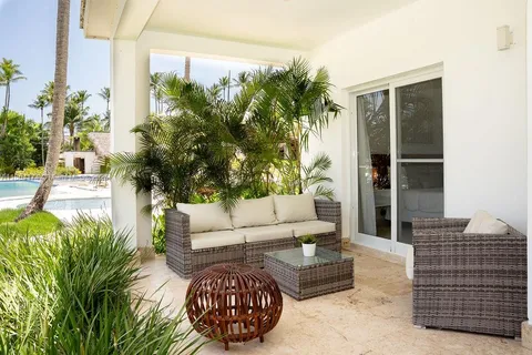 a living room with furniture and a potted plant