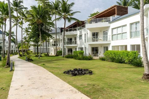 a view of a house with a yard and potted plants