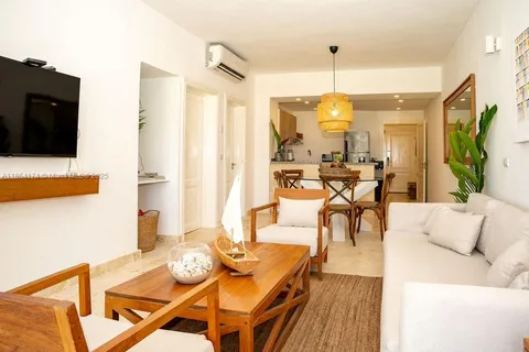 a living room with furniture and a chandelier