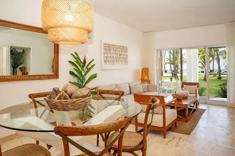 a dining room with furniture and a large window