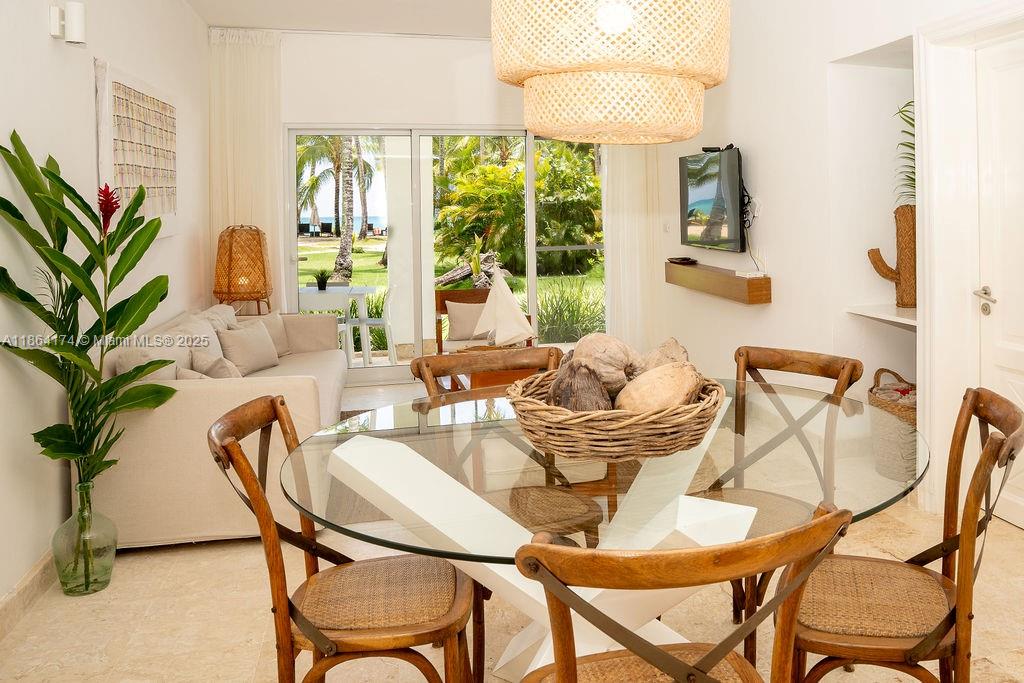 0 8c3f Q62, Unit LEVEL 1 Las Terrenas, Samaná Province 32000 - Photo 8 of 41 a dining room with furniture and large windows
