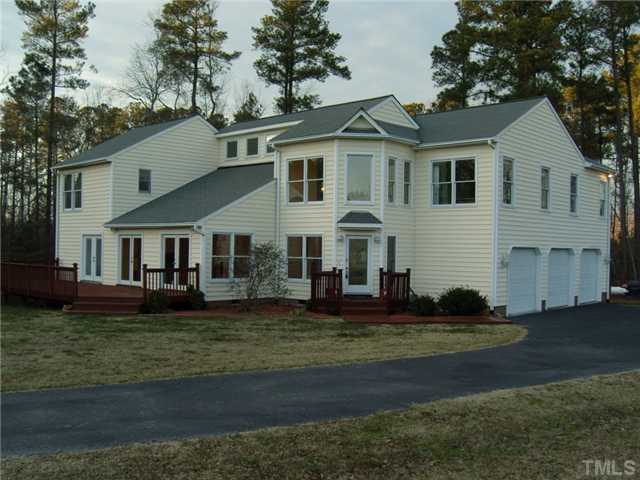 2030 Pilot-Riley Road Zebulon, NC 27597 - Photo 1 of 25 a front view of a house with a garden