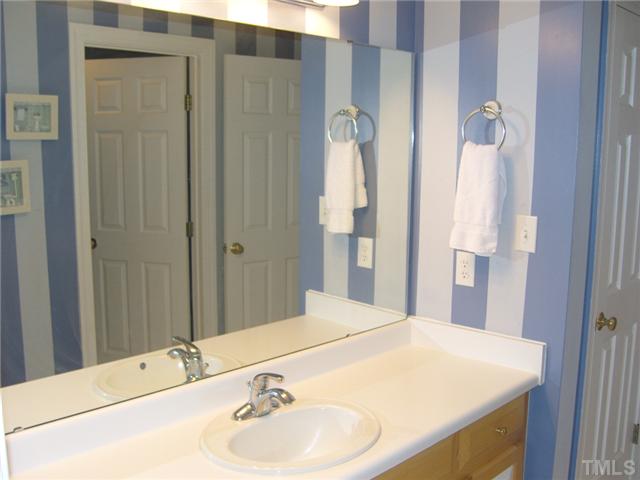 2030 Pilot-Riley Road Zebulon, NC 27597 - Photo 14 of 25 a bathroom with a sink and a mirror