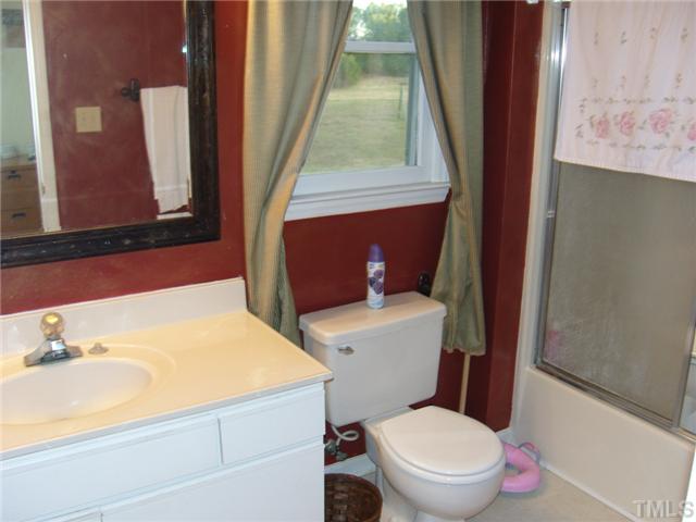 2030 Pilot-Riley Road Zebulon, NC 27597 - Photo 15 of 25 a white toilet sitting next to a bathroom sink